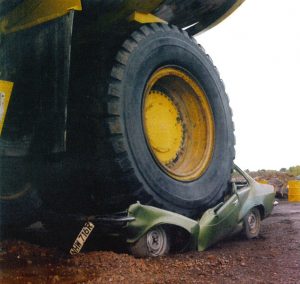 634px-Haul_truck_backed_over_a_parked_vehicle-300x284